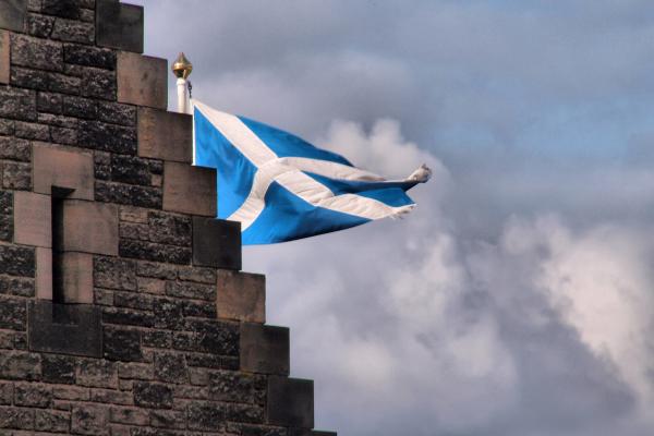 An image of the Scotland flag behind a building
